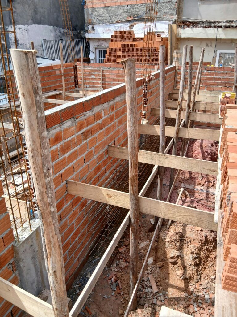 Residential construction site showing structural framing and foundation work, representing the step-by-step decision process in real estate investing.
