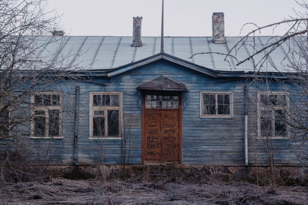 Weathered vacant house illustrating the importance of property value protection through ongoing maintenance and property preservation.